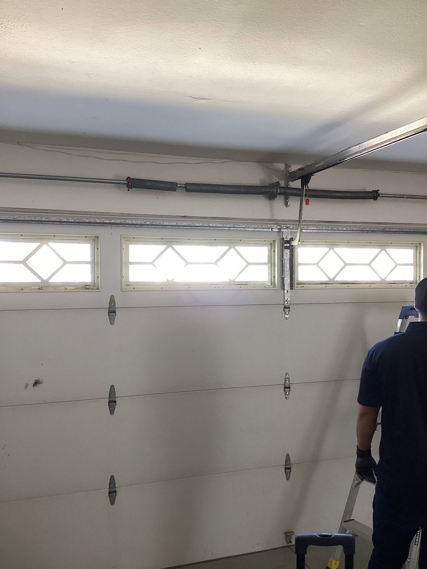 WeFix technician servicing a garage door in Jacksonville